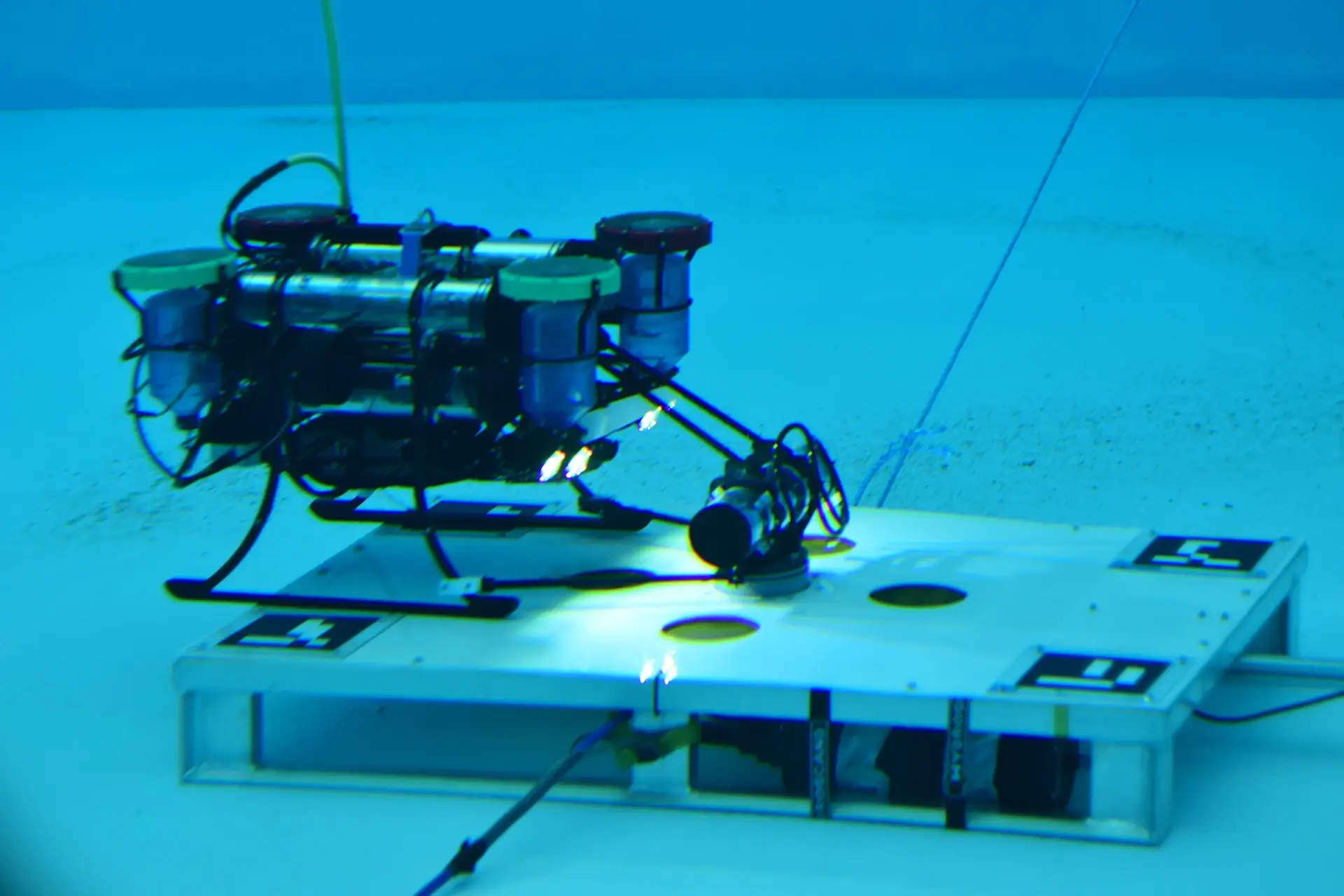 Photo showing our robosub docking with an underwater subsea structure.